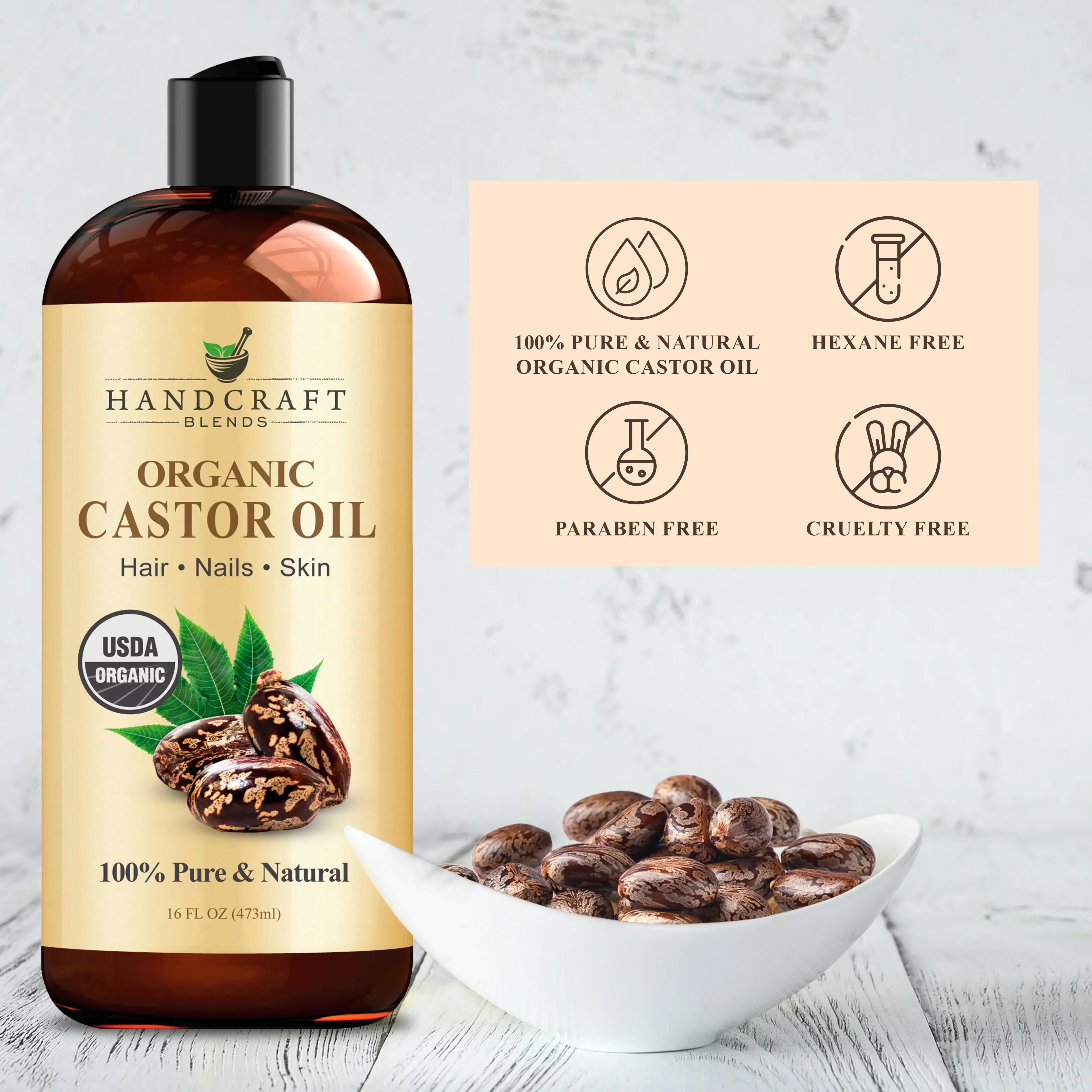 Organic castor oil bottle with castor beans in a bowl, USDA organic, paraben free, cruelty free.