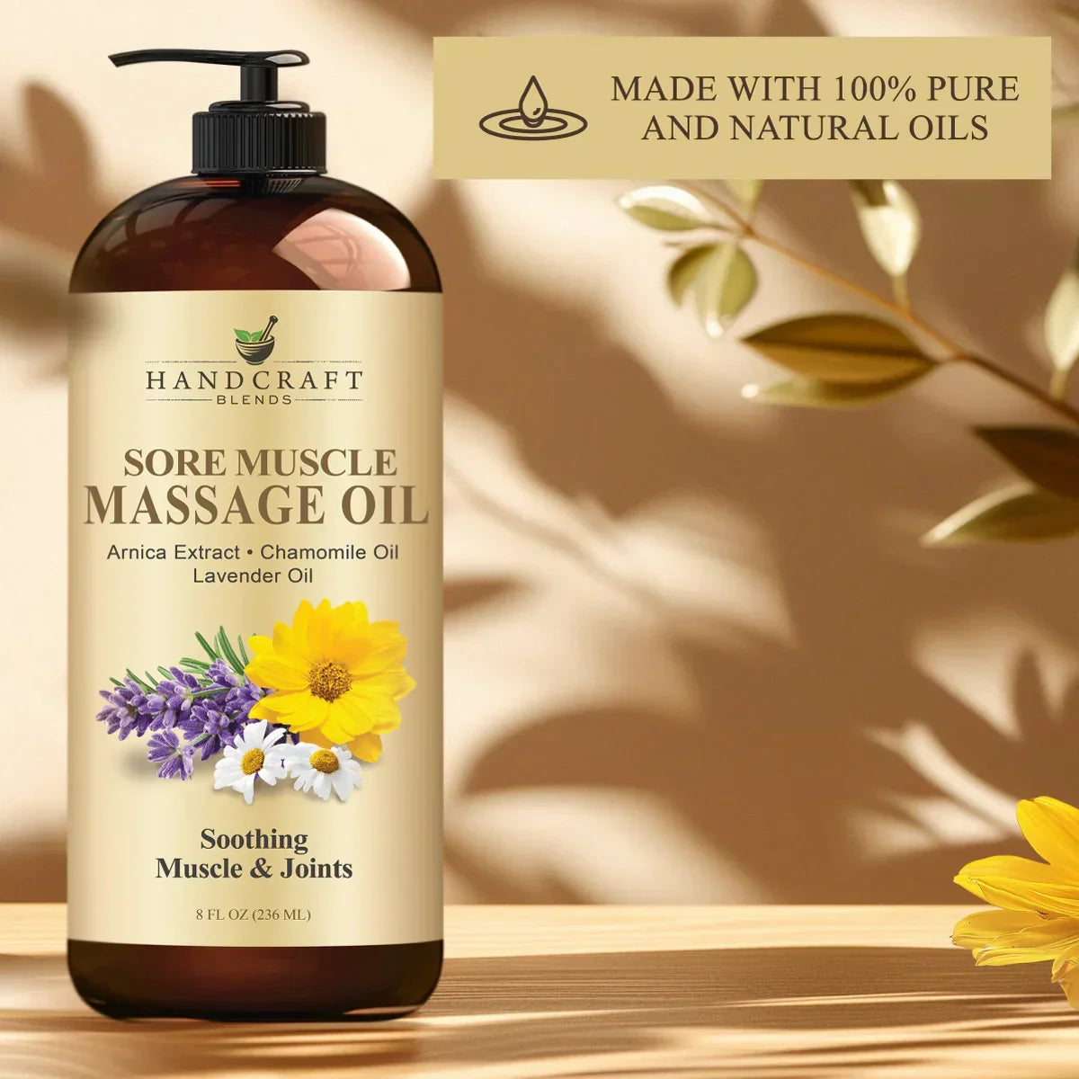 8oz sore muscle massage oil bottle with arnica, chamomile, and lavender oils on wooden surface