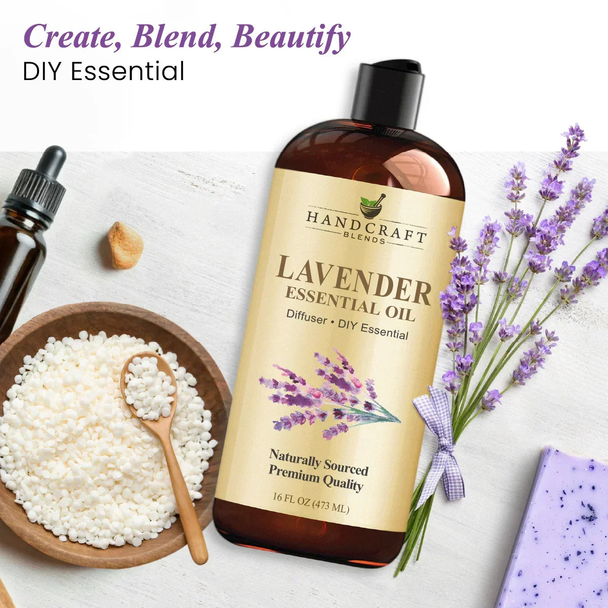 Lavender essential oil bottle with lavender flowers, bath beads, dropper, and soap on white background