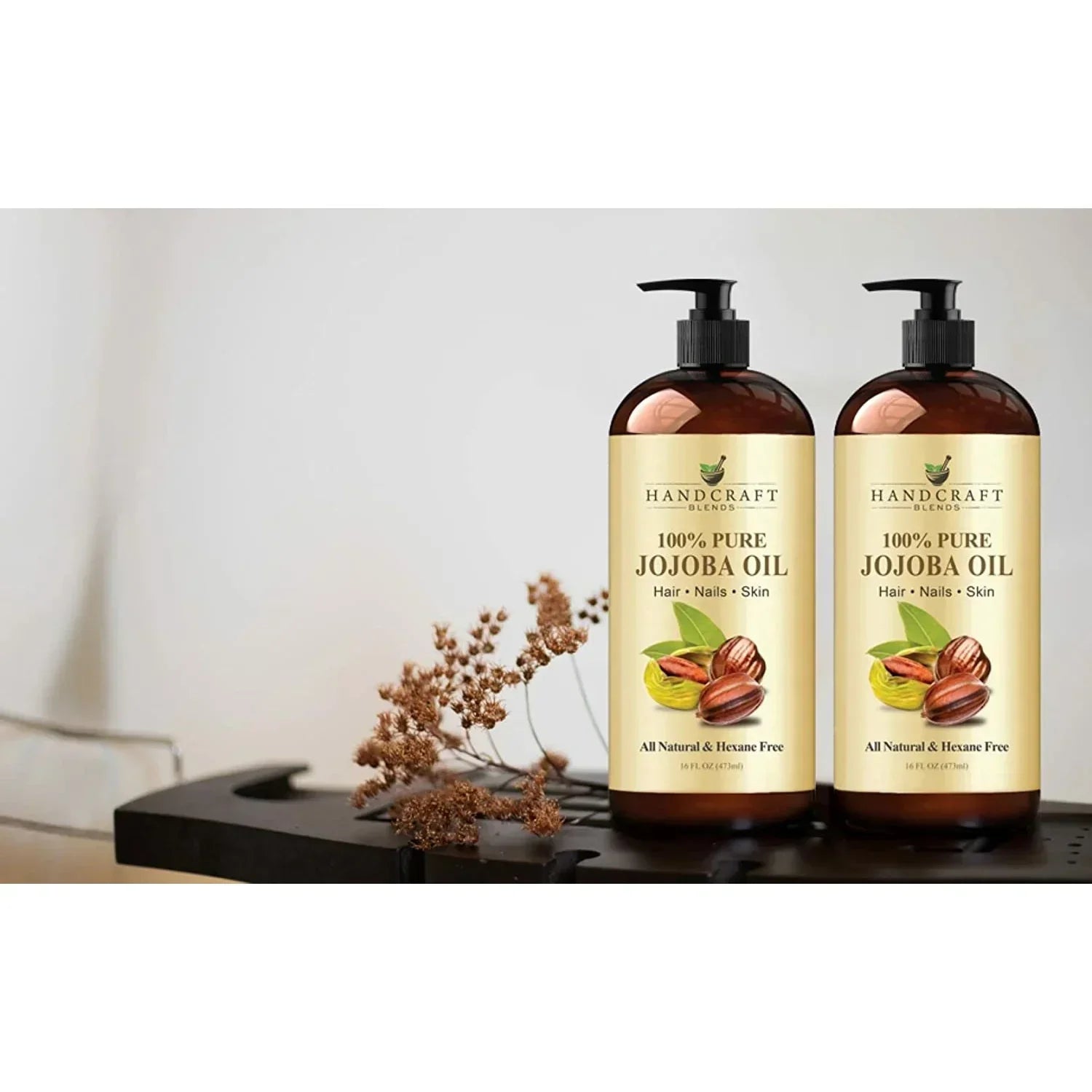 jojoba oil 2 bottles with a flower on the side