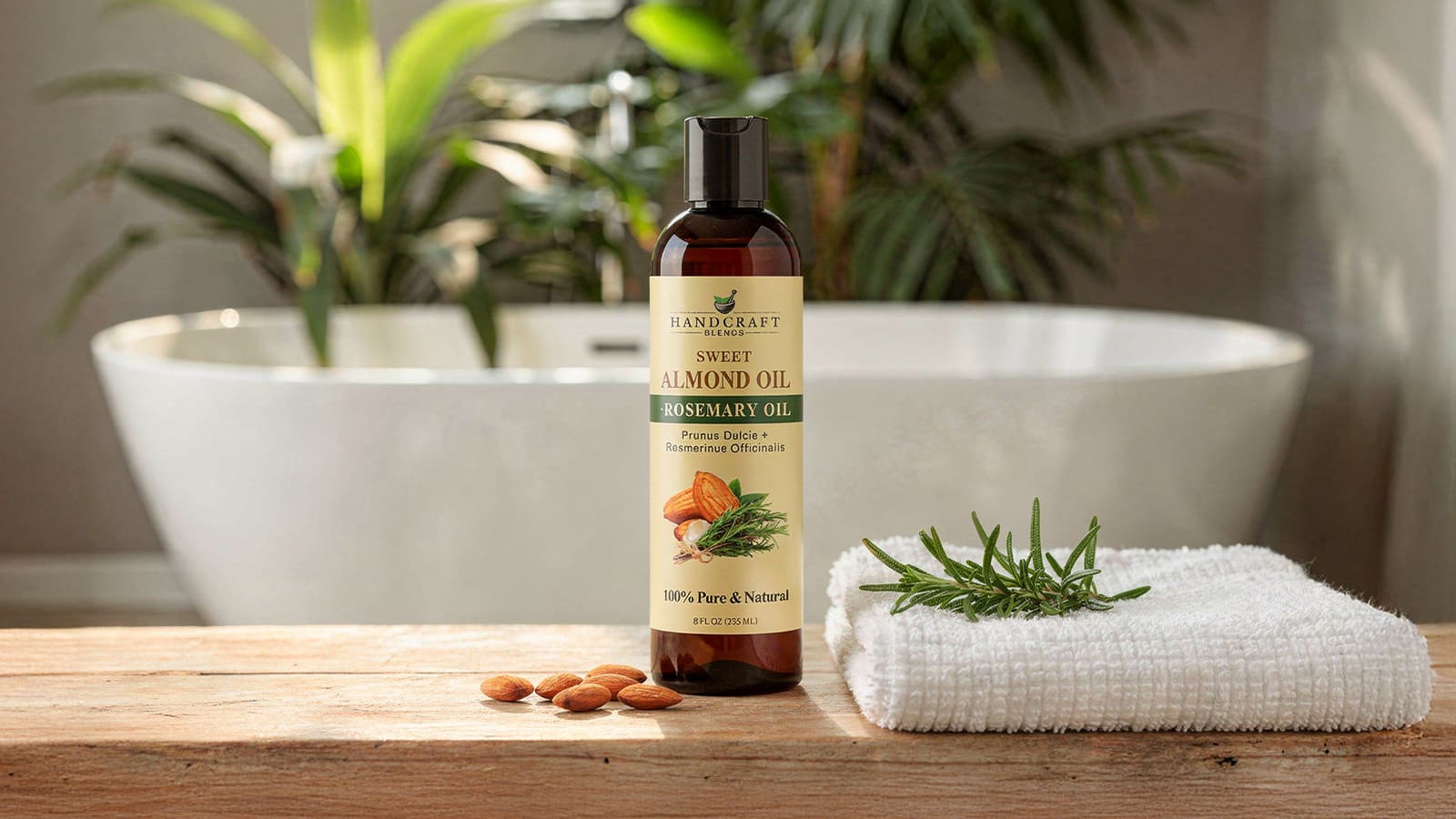Sweet almond oil and rosemary oil bottle on wooden table with almonds and rosemary, spa setting