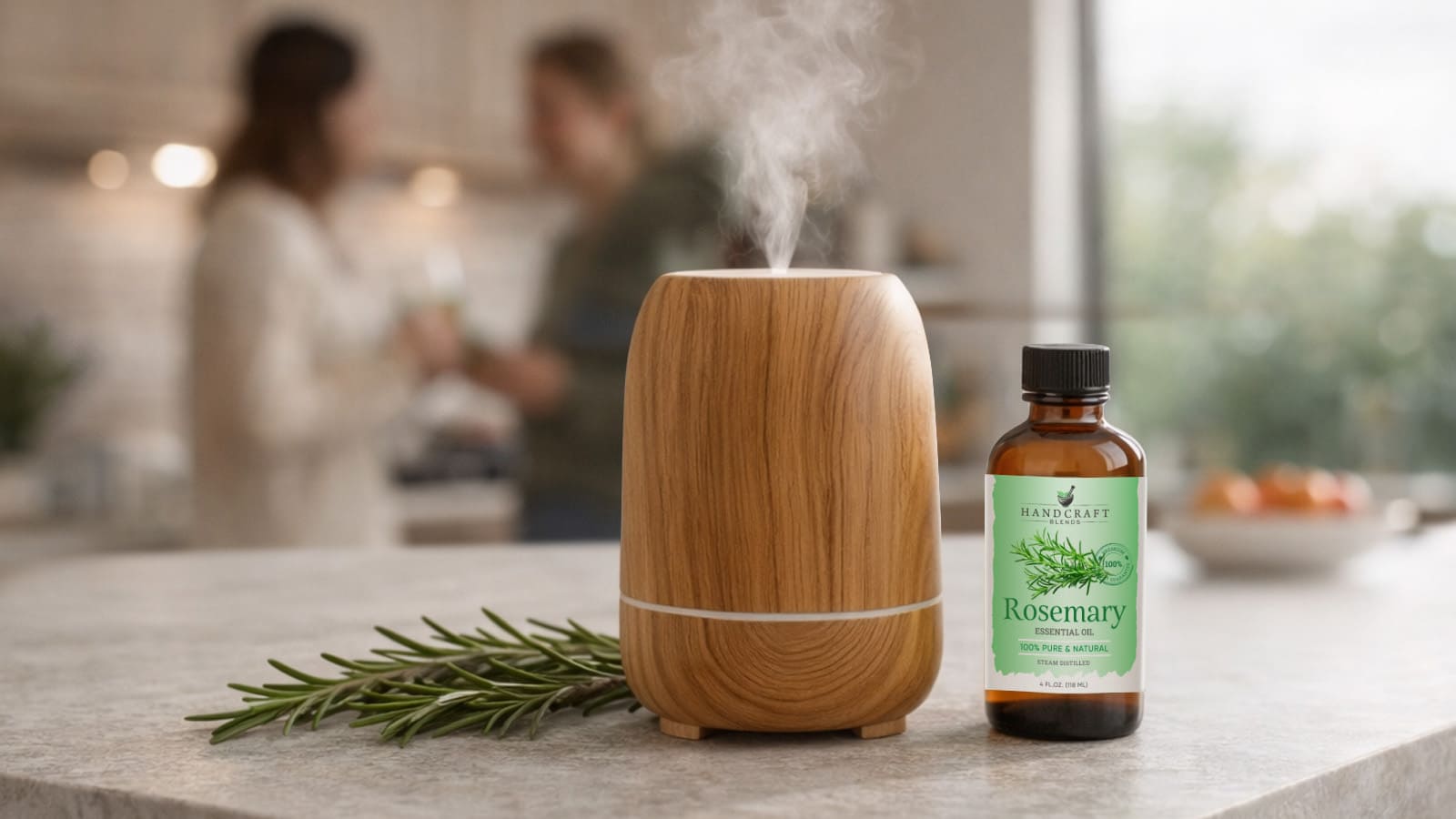 Rosemary essential oil bottle, wooden diffuser, and rosemary sprig on kitchen counter