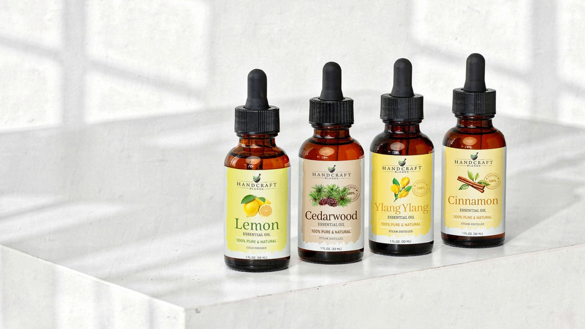Essential oil bottles arranged with seasonal pinecones, citrus, flowers, and autumn leaves