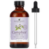 4oz amber glass bottle of camphor essential oil with dropper, labeled 100% pure and natural.